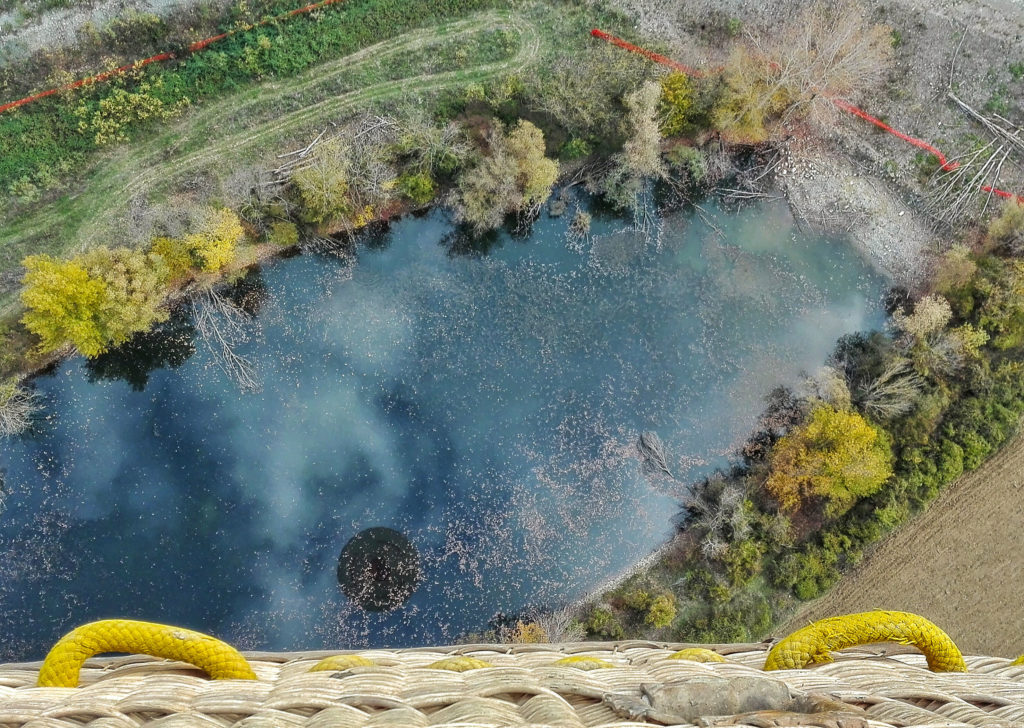 reflection of the balloon into a lake, seen from the basket