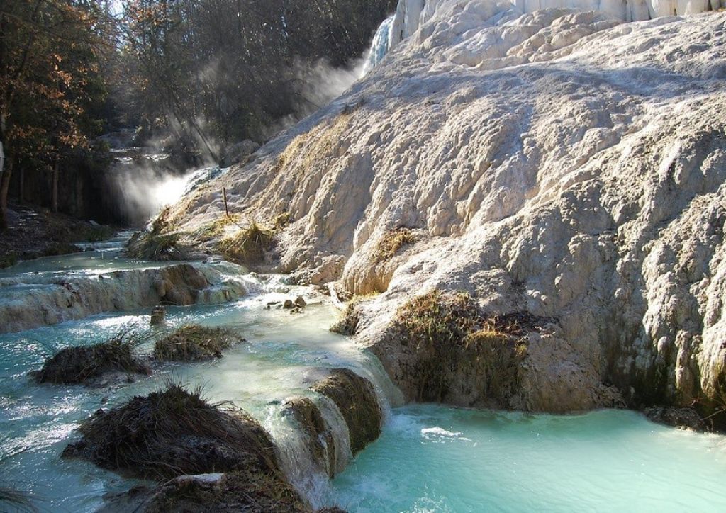 white limestone natural pools and light blue water at the hot springs in Bagno Vignoni, Tuscany