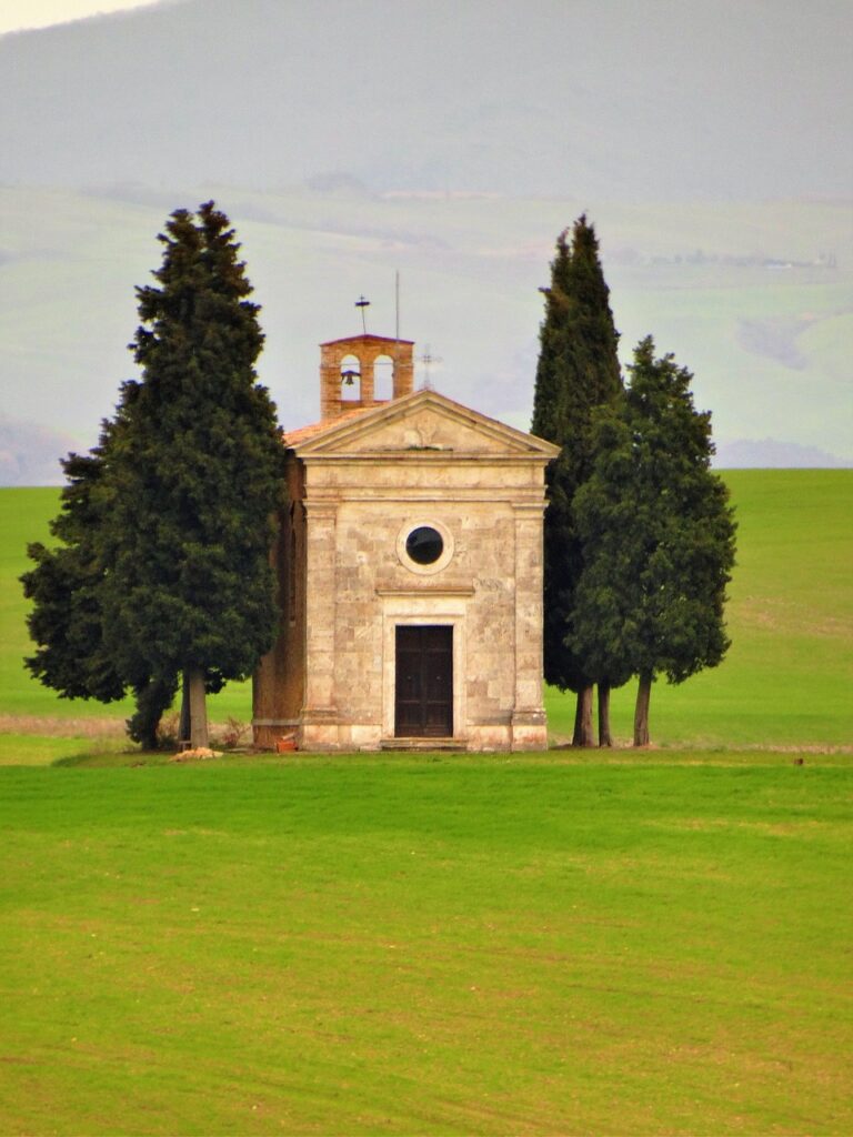 iconic little chapel in the countryside of Tuscany, with cypresses