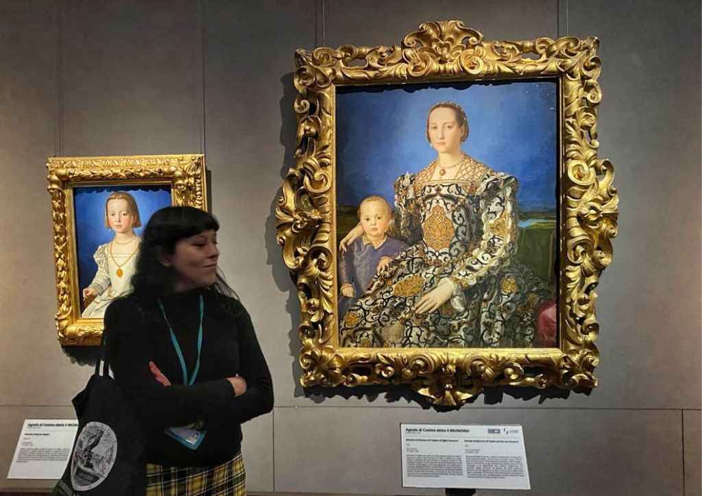 a tour guide in front of painting at the Uffizi Gallery, one of the best museums in Florence to visit