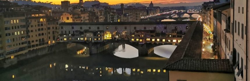 sunset over the Arno river seen from the window of the Uffizi gallery