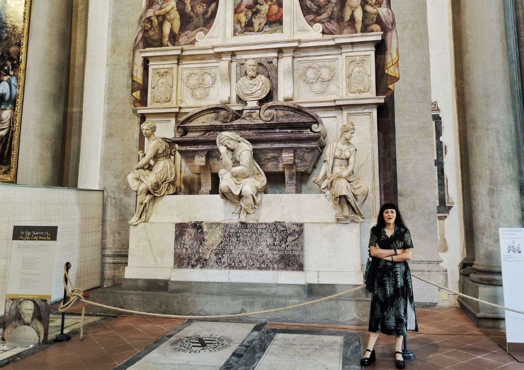 tour guide in front of the grave of Michelangelo in the church of Santa Croce in Florence