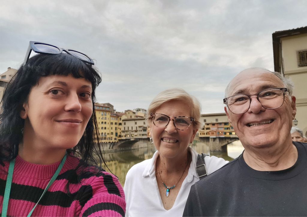 tour guide and clients in front of Ponte Vecchio, planning a trip to Florence