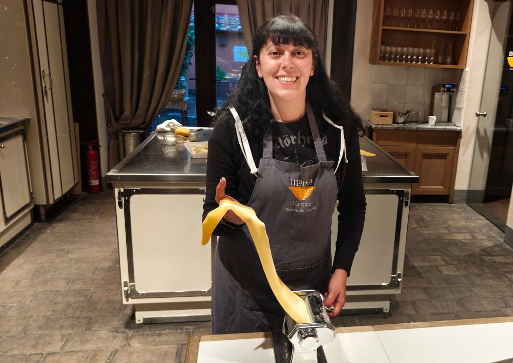 girl learning how to make fresh handmade pasta at a cooking school