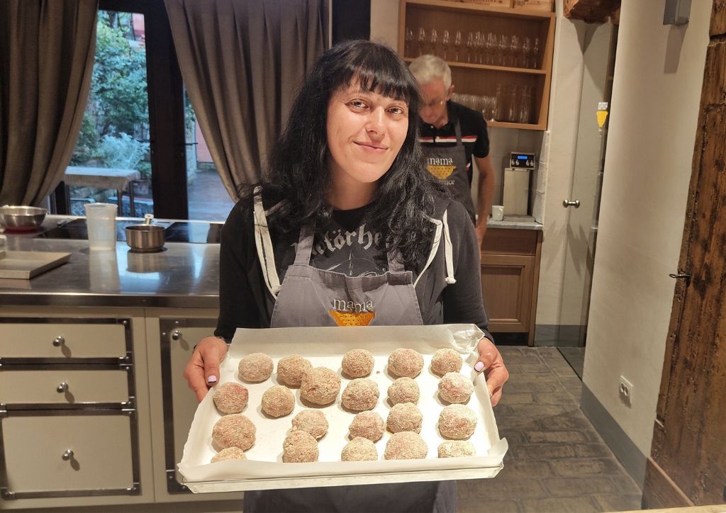 lady with a tray of meatballs at a cooking class in Florence Italy