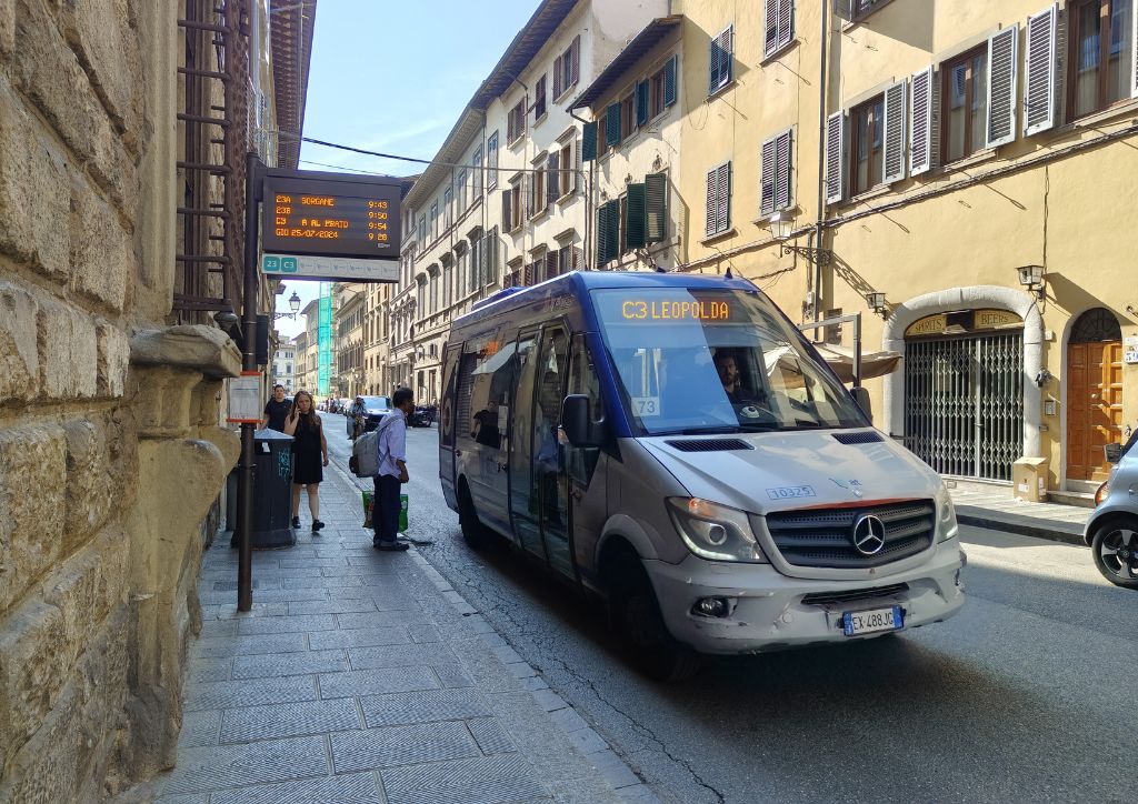 electric bus at a bus stop, in the streets of the historic center of Florence