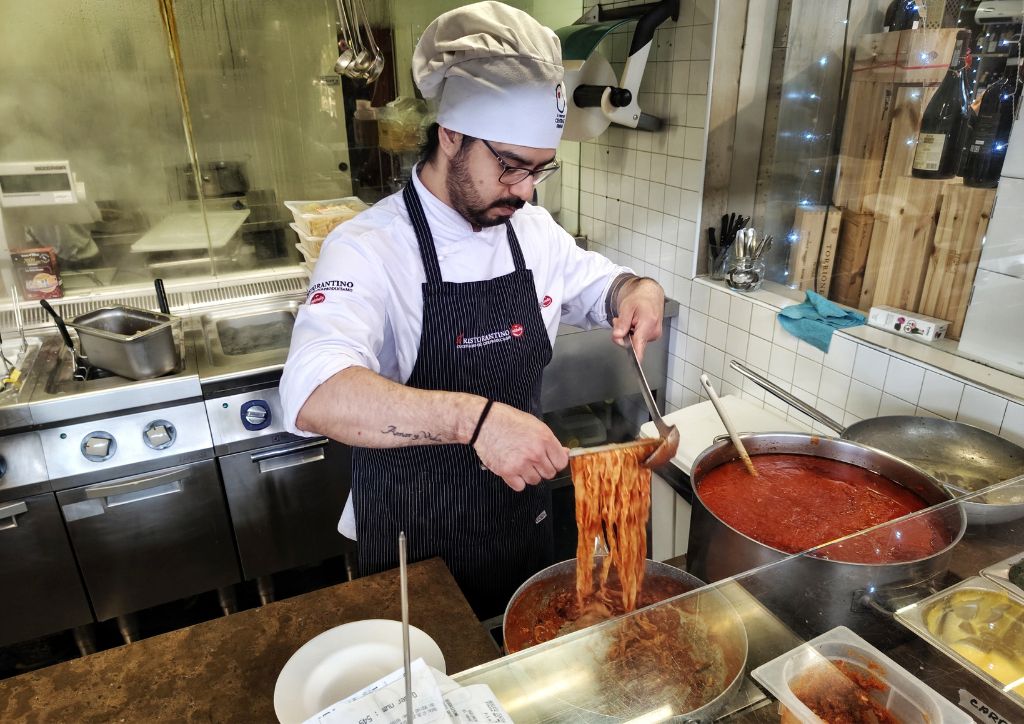 chef making pasta at Famiglia Michelis restaurant at Mercato Centrale in Florence